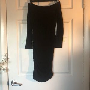 Leg ruched fitted black dress.